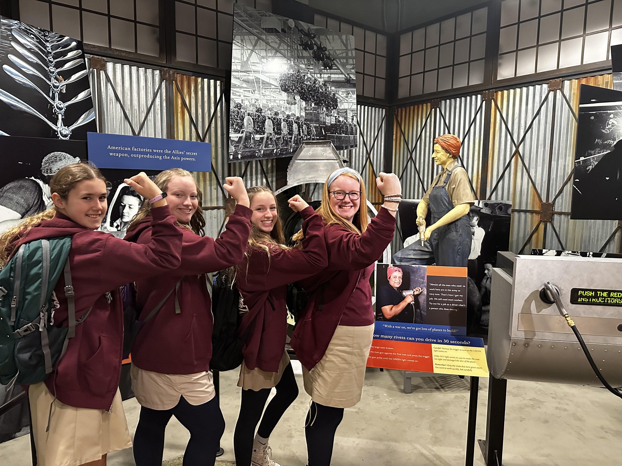 Students posing with Rosie the Riveter