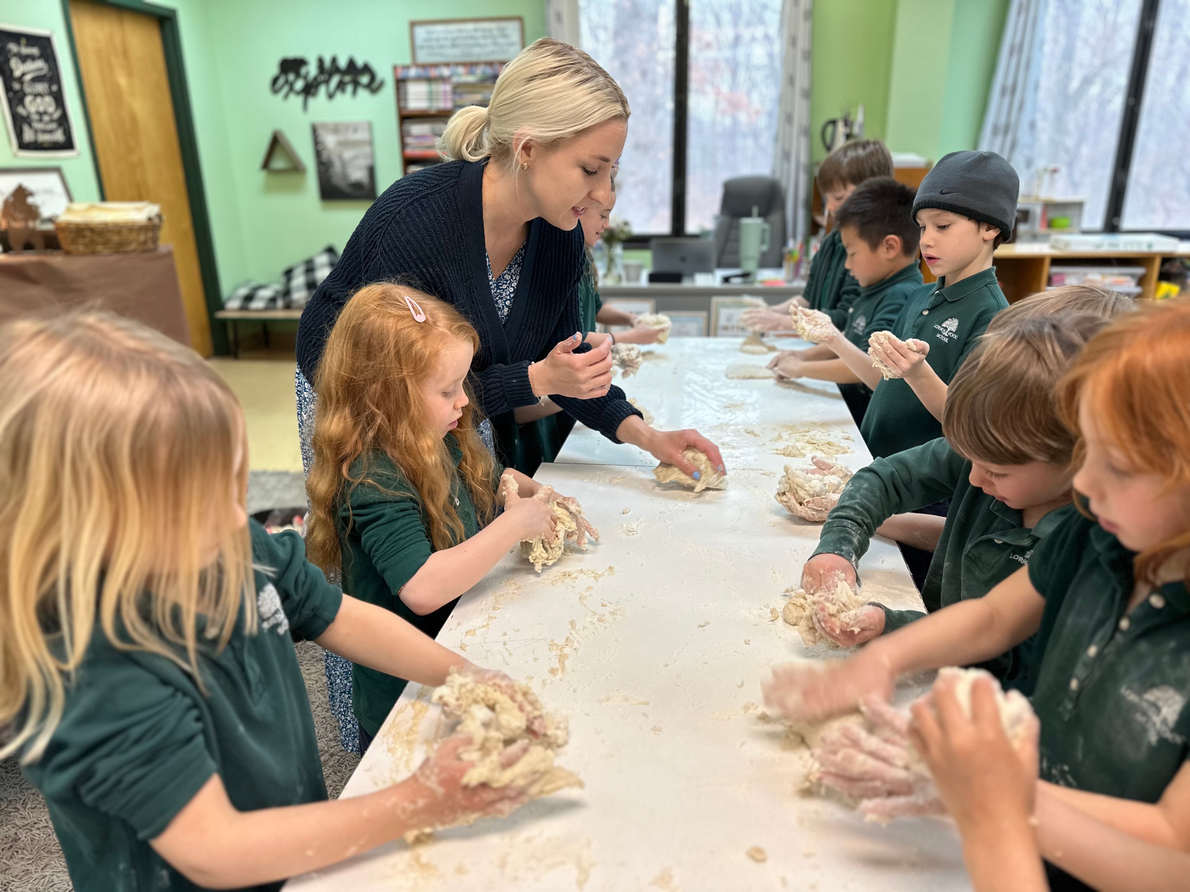 students kneading dough in the classroom